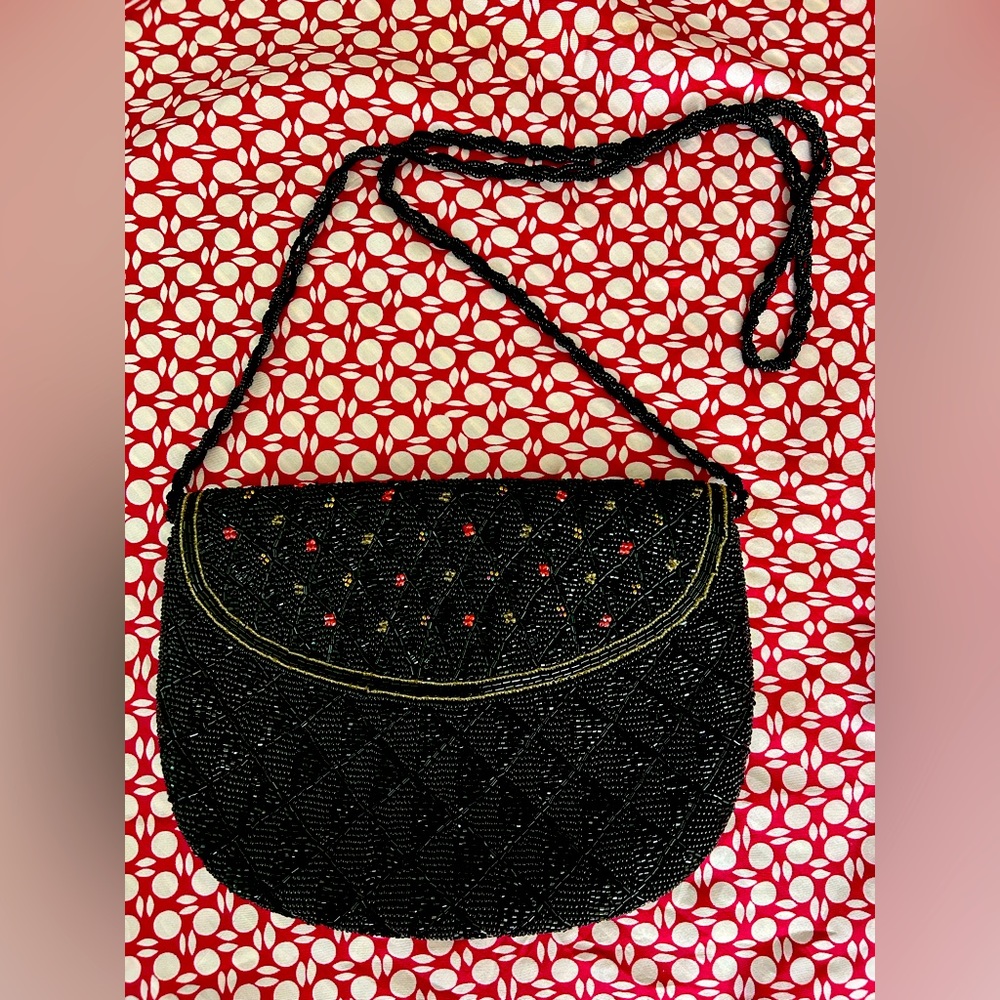 Royal Hock beaded black purse with red & gold beaded accent. 32” beaded strap